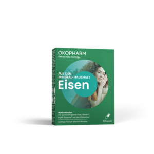 Packung für Nahrungsergänzungsmittel mit Eisen, grün, enthält Vitamin C, Kupfer und B-Vitamine, abgebildete Frau im Hintergrund.