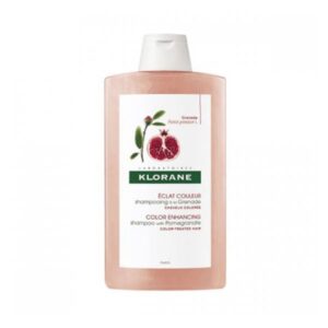 Flasche Klorane Shampoo mit Granatapfel-Extrakt für coloriertes Haar, rosa Verpackung mit grünem Etikett.