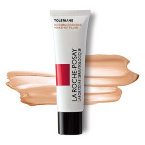 Röhre mit korrigierendem Make-up Fluid von La Roche-Posay, umgeben von einer Makeup-Farbe in Hauttönung.