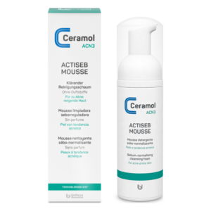 Reinigungsprodukt in einer weißen Flasche mit Pumpe und Kartonverpackung, für acne-neigende Haut.